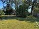 Large backyard with grassy area and trees at 5581 Aeolus Way, Orlando, FL 32808