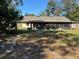 View of the home's backyard with large screened-in back porch at 5581 Aeolus Way, Orlando, FL 32808