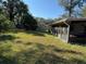 Large grassy backyard with mature trees at 5581 Aeolus Way, Orlando, FL 32808