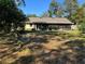 View of the home's backyard and surrounding trees at 5581 Aeolus Way, Orlando, FL 32808