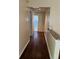 Hallway features updated flooring, neutral paint, and leads to another room; access to attic at 5581 Aeolus Way, Orlando, FL 32808