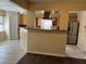 Kitchen with light wood cabinets, granite counters and stainless steel appliances at 5581 Aeolus Way, Orlando, FL 32808