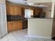 Kitchen with light wood cabinets and granite countertops at 5581 Aeolus Way, Orlando, FL 32808