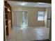 Bright living room with tiled floors and built-in shelves at 5581 Aeolus Way, Orlando, FL 32808