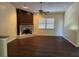 Living room with fireplace, wood-look floors, and ceiling fan at 5581 Aeolus Way, Orlando, FL 32808