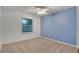 Bedroom with blue accent wall and ceiling fan at 601 Kelly Green St, Oviedo, FL 32765