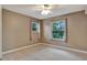 Bedroom with neutral walls, ceiling fan and window at 601 Kelly Green St, Oviedo, FL 32765