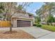 Two-story house with driveway, landscaping, and wooden fence at 601 Kelly Green St, Oviedo, FL 32765