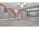 Open concept living area with hardwood floors, gray walls, and a view of the staircase at 601 Kelly Green St, Oviedo, FL 32765