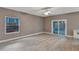 Living room with wood-look floors and sliding glass doors to patio at 601 Kelly Green St, Oviedo, FL 32765