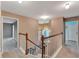 Upstairs hallway with view of staircase and bedrooms at 601 Kelly Green St, Oviedo, FL 32765