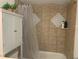 Clean bathroom with tile shower/tub and a white cabinet at 6073 Windhover Dr # C04, Orlando, FL 32819