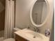 Bathroom with sink, toilet, and mirror at 6073 Windhover Dr # C04, Orlando, FL 32819