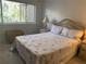 Bedroom with wicker bed frame and patterned quilt at 6073 Windhover Dr # C04, Orlando, FL 32819