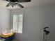 Empty bedroom with large window and stacked storage containers at 6073 Windhover Dr # C04, Orlando, FL 32819
