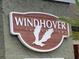 Windhover Condominiums brown sign with white lettering and a birds in flight logo at 6073 Windhover Dr # C04, Orlando, FL 32819