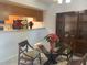 Dining room features a glass top table with three chairs and a built in wood china cabinet at 6073 Windhover Dr # C04, Orlando, FL 32819