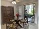 Dining area with glass table and four chairs, adjacent to kitchen at 6073 Windhover Dr # C04, Orlando, FL 32819