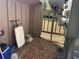 Enclosed patio area with wood plank walls, gravel base, and a white folding table at 6073 Windhover Dr # C04, Orlando, FL 32819