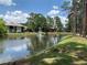 Community pond with fountain and trees at 6073 Windhover Dr # C04, Orlando, FL 32819