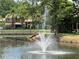 Scenic pond with a fountain and walking bridge at 6073 Windhover Dr # C04, Orlando, FL 32819