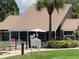 Exterior shot of the community pool area with a palm tree and lush landscaping at 6073 Windhover Dr # C04, Orlando, FL 32819