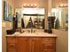 Bathroom vanity featuring drawers and an expansive mirror with decorative accents and unique artistic touches at 686 Lake Villas Dr # 686, Altamonte Springs, FL 32701