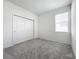 Spacious bedroom with grey carpet and double doors at 776 Rioja Dr, Minneola, FL 34715