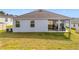 Single-story home with backyard patio and grassy area at 776 Rioja Dr, Minneola, FL 34715