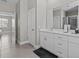 Clean bathroom with white cabinets and a large mirror at 803 Fraser Dr, Poinciana, FL 34759