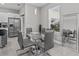 Modern glass dining table with gray chairs in a bright space at 803 Fraser Dr, Poinciana, FL 34759