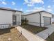 Modern home exterior with gray garage and walkway at 803 Fraser Dr, Poinciana, FL 34759