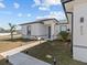 Modern home exterior featuring a walkway and landscaping at 803 Fraser Dr, Poinciana, FL 34759