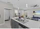 Island kitchen with stainless steel appliances and white cabinets at 803 Fraser Dr, Poinciana, FL 34759