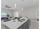 Kitchen island with double sinks, white cabinets, and quartz countertops at 803 Fraser Dr, Poinciana, FL 34759