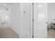 Clean hallway with carpet and doors to bedrooms at 8156 Elion St, Orlando, FL 32827