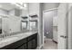 Bathroom with dual sinks, granite countertop, and a walk-in shower at 9737 Amber Chestnut Way, Winter Garden, FL 34787