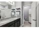 Double vanity bathroom with granite countertops and a linen closet at 9737 Amber Chestnut Way, Winter Garden, FL 34787