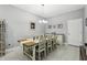Elegant dining room with seating for six, stylish lighting, and a neutral color palette at 9737 Amber Chestnut Way, Winter Garden, FL 34787
