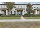 Two-story townhome with front porch and landscaped yard at 9737 Amber Chestnut Way, Winter Garden, FL 34787