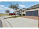 Townhouse exterior with gray garage doors and landscaping at 9737 Amber Chestnut Way, Winter Garden, FL 34787