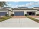 Two-car garage with paved driveway at 9737 Amber Chestnut Way, Winter Garden, FL 34787