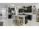 Modern kitchen with dark cabinetry and granite countertops at 9737 Amber Chestnut Way, Winter Garden, FL 34787