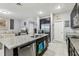 Modern kitchen featuring stainless steel appliances, granite countertops, and ample cabinet space at 9737 Amber Chestnut Way, Winter Garden, FL 34787