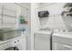 Laundry room with washer, dryer, and ample shelf storage at 9737 Amber Chestnut Way, Winter Garden, FL 34787