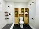 Modern bathroom with hexagon tile floor, a walk-in shower, and stylish wood cabinet at 10118 Allenby Ct, Orlando, FL 32821
