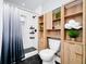 Well-appointed bathroom featuring a shower, toilet, and built in wood shelving at 10118 Allenby Ct, Orlando, FL 32821
