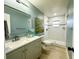 Spa-like bathroom with a walk-in shower, gray vanity, and an accent wall at 10118 Allenby Ct, Orlando, FL 32821