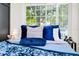 Close up on a stylish bedroom with a bed adorned with plush pillows and a window at 10118 Allenby Ct, Orlando, FL 32821