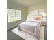 Bright bedroom with a plush bed, large window, and stylish decor at 10118 Allenby Ct, Orlando, FL 32821